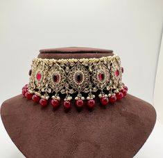 - Beautiful Minimalistic Red Choker Set - Perfect for bridesmaids boxes  - Perfect for Weddings, Brides, Casual Events, Diwali, Eid  - 100% Satisfaction Guarantee: Long Lasting Plating, High-Quality Stones - Adjustable neck width  - Small to Medium size - Wearable with any outfit - Easy to wear and remove - Premium Quality and High craftsmanship Care Tips - Keep away from water, perfume and other chemicals - Store it in a zip lock or container/box - Avoid direct heat Please contact us for any qu Red Jhumkas For Ceremonial Use During Diwali, Festive Red Temple Necklace, Red Temple Necklace With Stone Work For Festivals, Heavy Red Temple Necklace For Festive Occasions, Red Bollywood Temple Necklace With Stone Work, Bollywood Style Red Temple Necklace For Celebrations, Red Meenakari Temple Necklace For Ceremonial Occasions, Red Bollywood Temple Necklace For Celebration, Red Kundan Temple Necklace For Festivals