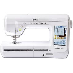 the brother sewing machine is white and has an applique on it's side