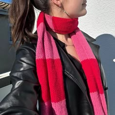 a woman wearing a pink and red scarf