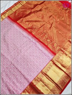 This very contemporary designer pure kanchipuram saree is crafted in pink boasting with dark pink animal skin design throughout the body and a korvai grand reddish orange pallu is adorned with paisley, strips,khumba and floral motifs, this saree features a beautiful korvai reddish orange 12inch border on one side and a smaller border on the other side with khumba ,florals and bird motifs. This saree comes with a designer look blouse piece in reddish orange with big border matching the border and Pink Pre-draped Saree With Motifs, Pink Pre-draped Saree With Motifs For Puja, Festive Pink Pre-draped Saree With Motifs, Designer Wedding Saree For Navratri, Designer Saree For Wedding And Navratri, Gold Designer Saree In Traditional Drape, Designer Pink Traditional Festive Wear, Designer Pink Traditional Wear For Festive Occasion, Designer Pink Saree With Motifs