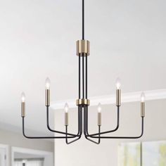 a black and gold chandelier with five lights hanging from it's center