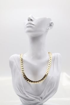 The Gold Cuban Link Necklace features thick, tightly interlocking links in polished gold, delivering a bold and luxurious statement. Its timeless design exudes elegance and sophistication, making it a versatile piece for both casual and formal occasions. Length: 17” Closure: Spring Ring Material: Brass with 18K Gold Plating with Rhodium Coating Lead Free and Hypoallergenic Formal Cuban Link Necklace With Figaro Chain, Elegant Cuban Link Chain Necklace For Parties, Gold Cuban Link Necklace With Solid Links As Gift, Elegant Gold-tone Cuban Link Necklace, Formal Cuban Link Necklace With Adjustable Chain, Elegant Metal Chain Necklace With Cuban Link, Formal Gold-plated Chain Necklace With Rectangular Links, Cuban Link Metal Necklace For Formal Occasions, Elegant Cuban Link Metal Chain Necklace