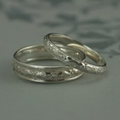 two wedding rings sitting on top of each other