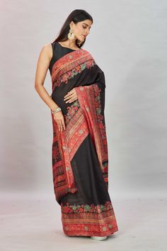 The elegance of this black Kani weave sari is sure to leave everyone awestruck! It is enhanced with a contrasting red border and pallu and comes with a matching blouse piece. Disclaimer: The shown stitched blouse on the model is for display purpose only. The saree comes with a matching blouse piece and finished with fall and piko. Red Semi-stitched Saree With Embroidered Border, Black Saree With Red Border, Red Semi-stitched Saree With Border, Red Semi-stitched Pre-draped Saree With Printed Border, Black Saree With Printed Border, Tussar Silk Sarees, Indian Clothing Store, Latest Designer Sarees, Red Border