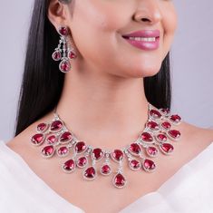 Elevate your bridal wedding elegance with Agulka Jewels' exquisite Ruby Necklace, adorned with dazzling Red Diamonds and delicate Pink Sapphires. This American Diamond Necklace Set captures the rich heritage of India's jewelry tradition, adding opulence and sophistication to your special day ensemble. Trust Agulka Jewels to make your wedding attire truly unforgettable with this stunning India-inspired jewelry, celebrating timeless beauty and culture. *𝐏𝐑𝐎𝐃𝐔𝐂𝐓 𝐃𝐄𝐓𝐀𝐈𝐋* * Material: Brass * Plating: White Rhodium Plated * Stone: AAA Quality CZ Diamon & Ruby. *𝐃𝐈𝐌𝐄𝐍𝐒𝐈𝐎𝐍𝐒* *Necklace* * Weight:  107 gm  * Length: 8.2 Inches * Drop Length: 5.7 Inches * Width: 2.2 Inches *Earrings* * Weight: 10 gm Each * Length:  2.25 Inches * Width: 1.5 Inches * Closure: Push Back *𝐒𝐇𝐈𝐏? Red Stone Work Jewelry For Formal Occasions, Red Formal Jewelry With Stone Work, Formal Red Jewelry With Stone Work, Red Jewelry Sets For Formal Festivals, Elegant Kundan Necklace With Ruby For Reception, Elegant Red Kundan Necklace For Festive Occasions, Elegant Red Kundan Bridal Necklace, Festive Gemstone Bridal Necklace For Reception, Elegant Red Kundan Necklace For Reception