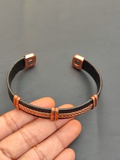 you will receive 1 piece of Solid Copper Leather Wrapped Magnetic Cuff Bangle Bracelet Handmade Arthritis Pain Therapy Energy Healing Cuff Bangle For Her  Inner diameter Size - 2.6" approx. Bangle Width Size : 11 mm Material: Leather Quantity: 1 Piece Thank you very much for visiting! Any questions, please feel free to contact us. Discount for bulk provide. Handmade Adjustable Black Bangle, Adjustable Black Handmade Bangle, Adjustable Handmade Black Bangle, Unique Adjustable Leather Bangle Bracelet, Adjustable Copper Cuff Bracelet Spiritual Style, Adjustable Copper Spiritual Cuff Bracelet, Adjustable Brown Copper Bangle, Spiritual Copper Cuff Bracelet With Adjustable Fit, Spiritual Adjustable Copper Cuff Bracelet