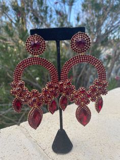 oversized deep red/ garnet earrings    length: 5.5 inches long by 2.5 inches wide Glamorous Red Chandelier Earrings For Evening, Red Glamorous Chandelier Earrings For Evening, Ruby Chandelier Drop Earrings For Party, Red Glamorous Chandelier Earrings For Party, Glamorous Red Chandelier Earrings For Party, Burgundy Drop Earrings For Party, Burgundy Earrings For Party, Elegant Red Teardrop Chandelier Earrings, Luxury Red Dangle Chandelier Earrings