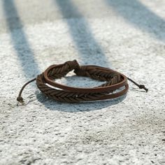 Available in coconut brown, this multi-strand adjustable bracelet features waxed leather cord. Size: Approximately 5mm thick. Casual Leather Bracelet With Adjustable Cord, Masculine Brown Leather Braided Bracelet, Adjustable Waxed Leather Bracelet, Adjustable Rugged Leather Bracelet, Adjustable Rustic Leather Bracelet, Brown Handmade Leather Bracelet With Waxed Cord, Casual Brown Bracelet With Adjustable Cord, Adjustable Brown Leather Braided Bracelet, Adjustable Leather Braided Bohemian Bracelets