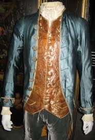 a mannequin dressed in a blue and gold suit