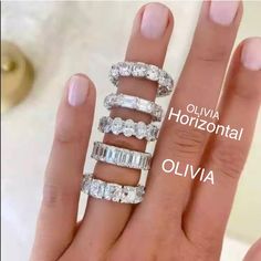 a woman's hand with three rings on it and the words olvia horizontal