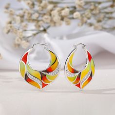 These statement earrings are definitely the eye-catcher at any place, time or event. These fashion earrings are tastefully designed with multicolored enamel work and sterling silver to steal everyone's attention in the classiest way possible. The flawless enamel work coupled with white stones, make these hoop earrings perfect for a casual occasion. Add this beautiful enamel piece to your jewelry box and you won't be disappointed.Carat Weight: 0.659 ctStone Size: 1.1,1.3,1.6 mmStone Type: Jeulia® Multicolor Enamel Jewelry Hallmarked, Multicolor Hallmarked Enamel Jewelry, Multicolor Enamel Earrings, Colorful Enamel Hoop Earrings, Multicolor Enamel Hoop Earrings, White Stone, Lovely Earrings, Anniversary Sale, Earring Necklace