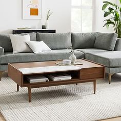 a living room with a sectional couch and coffee table