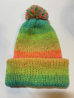 *This is an Addi Express knitted beanie made in soft acrylic yarn. *Beanie is double layered and reversible with a removable pom-pom.   *The beanie fits an older teen and average adult. * All of my handmade items come from a non-smoking home.   *Sales are final. *Ready to ship. Care Instructions: Remove pom-pom and hand-wash.  Line air dry. Note:  If you would like an item made to order, feel free to contact me. THANK YOU for supporting my small business 😊. Adjustable Acrylic Yarn Beanie For Cold Weather, Adjustable Knitted Green Bonnet, Adjustable Green Knitted Bonnet, Playful Green Crochet Hat For Winter, Fun Green Crochet Hat For Winter, Green Fun Crochet Hat For Winter, One Size Acrylic Beanie Bonnet, Adjustable Acrylic Beanie For Cold Weather, Adjustable Acrylic Beanie