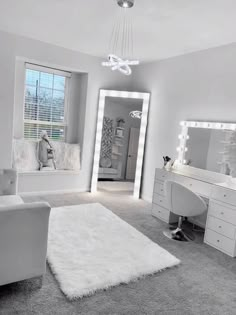 a bedroom with white furniture and large mirrors on the wall, along with a rug