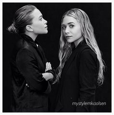 two women standing next to each other in front of a black background with one looking at the other