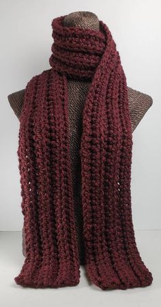 a red knitted scarf on top of a mannequin