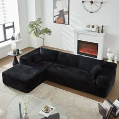 a living room filled with furniture and a fire place in the middle of the room