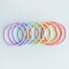 Brighten up a bare wrist or already bustling arm party with these candy colored seed bead stacking bracelets! Treat yo' self or your best friend to a cute, colorful beaded bracelet with any initials, names, or words! Length and text fully customizable upon request. Standard lengths are 7" for women, 8" for men, 5.5" for kids. **Please double check all personalization details and requests. All bracelets are custom made to order and all sales are final. **Treat jewelry with care and avoid exposure Casual Rainbow Friendship Bracelets With Tiny Beads, Casual Rainbow Beaded Bracelets With Letter Beads, Adjustable Pastel Bracelets With Round Beads, Casual Rainbow Beaded Bracelets With Tiny Beads, Rainbow Beaded Bracelets For Everyday, Everyday Rainbow Beaded Stretch Bracelet, Adjustable Pastel Beaded Bracelet, Trendy Beaded Pastel Bracelets, Pastel Beaded Bracelets With Colorful Round Beads