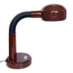 a brown desk lamp with a black cord on it's end and a white background