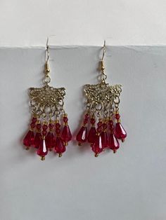 Red and gold dangly chandelier earrings Elegant Red Metal Danglers, Elegant Red Festive Danglers, Red Festive Dangle Earrings, Red Dangle Earrings For Festive Occasions, Festive Red Drop Earrings, Red Dangle Jewelry For Festivities, Red Metal Earrings For Celebration, Red Dangle Jewelry For Celebration, Red Dangle Jewelry For Festive Occasions