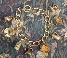 Beautiful thick (10x12mm) brass curb chain bracelet with 8  3D  brass charms. The charms are a mixture of new and vintage (unused) and include a handbag, rose, bird cage with hanging bird (new) and a frog on lilypad, coffee pot, telephone, kettle and carousel (vintage).  The bracelet is a lovely golden colour but as with all brass jewellery it will darken with time but can be repolished or left to form a natural patina as desired. The bracelet will be supplied in a velvet gift pouch. Cheap Vintage Charm Brass Jewelry, Affordable Vintage Charm Brass Jewelry, Luxury Vintage Charm Collectible, Affordable Vintage Gold Charm Bracelet, Luxury Vintage Charm Bracelet As A Gift, Cheap Vintage Brass Jewelry With Charm, Luxury Heirloom Bracelets With Vintage Charm, Luxury Retro Bracelet As Gift, Luxury Vintage Charm Bracelet With Jubilee Style