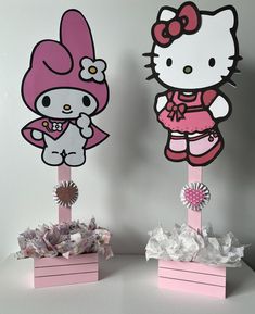 there are two hello kitty decorations on top of each other, one is pink and the other is white