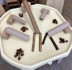 several pieces of paper are arranged on top of a table with chocolate candies and sticks