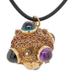 This is part of Chairish’s Fine Jewelry assortment.  This is a wonderful 18K gold Victorian Etruscan Revival multi-gem locket/pendant. There are a total of six bezel-set cabochon stones, two amethysts, two garnets, and two blue tourmalines. The piece has applied Etruscan beadwork. It is hinged and opens at the center. There are no marks, but it tests 18K. The condition is excellent.  Dimensions: Diameter from stone to stone: 1 1/4", Weight: 12.5 grams Luxury Yellow Gold Gemstone Cabochon, Yellow Gold Multi-stone Cabochons For Fine Jewelry, Yellow Gold Multi-stone Cabochons Fine Jewelry, Luxury Beads, Gems, And Cabochons For Formal Occasions, Antique Gold Multi-stone Necklace, Antique Gold Necklace With Multi-stones, Luxury Gold Gemstone Cabochons, Yellow Gold Multi-stone Cabochons For Gift, Yellow Gold Multi-stone Spiritual Necklace