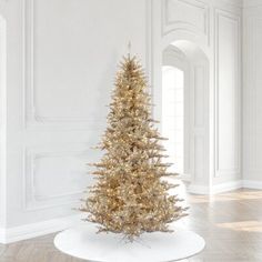 a small christmas tree in a white room