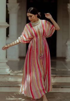 Editor's Note Our Multicolor Striped Kaftan Is Hand Embroidered With Sequins, Mirrors And Dabka Work Comes With A Tie Up Detail To Cinch The Waist Embellished With Handmade Embroidered Tassels Color: Multicolor Fabric: Crepe Care: Dry Clean Only About the Designer Paulmi & Harsh is a luxury prêt label inspired by beautiful botanicals. Paulmi & Harsh design strong, feminine silhouettes with prints and delicate detailing, fusing 1950’s fashion with modern-day sensibilities. Paulmi & Harsh are obse Indian Kaftans Dresses, Crepe Dress Designs, Printed Kaftan Designs, Kaftan Suit Design, Kaaftaan Designs, Kaftan Kurti Designs, Stylish Kaftan Dresses, Kaftans Dresses Modern, Stripes Kurti Designs Latest