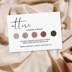 a business card with the words ate earth tones on it next to a fur pillow