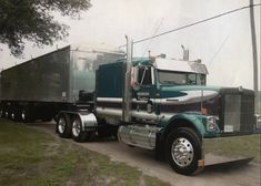 a large semi truck is parked on the side of the road