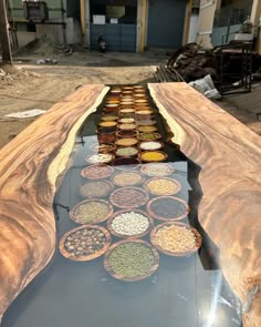 the table is made out of wood and has many different types of food on it