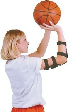 a woman in an orange skirt holding a basketball over her shoulder and arm braces