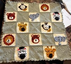 a crocheted blanket with animals on it