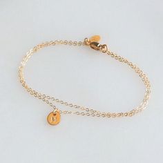 Our Double Chain Bracelet comes in silver, rose or gold chain options. Two sparkling chains for a minimal and chic look for everyday. Adorned with a tiny initial disc for that extra special touch.  Makes the perfect gift too! D E T A I L S -Two layers of dainty link chain -Tiny 6mm initial disc.  -High quality 14kt gold filled or sterling silver - not plated. LENGTH - Please select from the drop down selection. - Fits most sizing: 6.0 inches extra small 6.5 inches small 7.0 inches medium 7.5 inches large  CUSTOM HAND STAMPING  -Hand stamped  -One letter in Uppercase block or script font  -Can also be a symbol  HOW TO PERSONALIZE   -kindly leave your details in the note to seller box that will show up after you add the item to your cart.  ∙ EXTRA LOVE ∙ Crafted and curated just for you in t Double Chain Bracelet, Layered Bracelet, Jewelry Dainty, Personalized Bracelet, Dainty Bracelet, Double Chain, Dainty Bracelets, Personalized Bracelets, Layered Bracelets