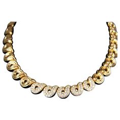 Designer necklace by Boucheron is a heavy 118.7 grams of 18K Yellow Gold and features ribbed swirl design links continuously wrapping the neck in an elegant pattern. Necklace features a hidden box clasp design secured with a fold under latch for additional safety. Approximately 16 inches long, the design is further enhanced with 3 carats of bright round brilliant cut diamond pave set on the center five links. Don't miss out on this truly stunning and timeless piece to add to your fine jewelry co Luxury Yellow Gold Necklace With Brooch, Luxury 22k Gold Necklaces, Gold And Diamond Necklace, Designer Necklace, Gold Diamond Necklace, Antique Diamond, Swirl Design, Fine Jewelry Collection, Link Necklace