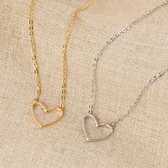 Our Heart Necklace is the epitome of understated elegance, offering a subtle yet powerful expression of love in its simplest form - a heart. This dainty heart necklace, featuring the delicate outline of a heart on a fine but sturdy chain, is more than just a piece of jewelry; it’s a symbol of the enduring nature of love in all its forms.Designed for versatility, this minimalist necklace seamlessly complements both casual and formal attire, making it a perfect choice for everyday wear or special Elegant Open Heart Charm Necklace With Delicate Chain, Heart Detail Necklace For Everyday Valentine's Day, Dainty Everyday Necklaces With Heart Detail, Dainty Heart Pendant Necklace With Heart Detail, Dainty Necklace With Heart Pendant Detail, Everyday Heart Detail Necklace For Valentine's Day, Classic Heart Pendant Necklace With Adjustable Chain, Dainty Cable Chain Necklace For Valentine's Day, Delicate Tarnish Resistant Necklaces For Valentine's Day