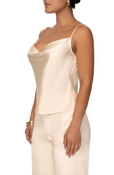 Add a graceful note to your look with the softly draped neckline of this luminous satin camisole. Cowl neck Adjustable straps 55% rayon, 45% viscose Hand wash, dry flat Imported Satin Cami For Night Out, Elegant Cowl Neck Tank Top For Night Out, Elegant Beige Cami Top, Satin Finish Camisole For Night Out, Satin Evening Camisole, Elegant Beige Spaghetti Strap Top, Elegant Satin Camisole With Built-in Bra, Evening Satin Camisole Top, Chic Satin Finish Tank Top