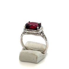 "Gorgeous 4 carat natural Rhodolite garnet in a vintage 14K white gold filigree ring.  Marked \"14K\".  Sure to be a favorite in your personal jewelry collection. FREE SHIPPING! Details: 14K White Gold: (as shown in picture) Natural Rhodolite Garnet: 10.1 mm x 8.2 mm cushion cut Actual Gem Weight: 4.13 carats Gem Color: Purplish Red Ring Size: 6 1/2 Total Weight: 4.2 grams FREE domestic shipping by USPS Priority Mail delivery confirmation and includes insurance. If the item is to be shipped internationally Etsy will calculate postage. Please notify us at purchase if you are buying more than one item and we will gladly combine shipping. 7 day \"no hassle\" return policy money back guarantee. If for any reason you are not 100% thrilled with your purchase, please contact us and we will gladly Filigree Ring Gold, Personal Jewelry, Red Ring, Garnet And Gold, Mail Delivery, Red Band, Rhodolite Garnet, Gold Filigree, Filigree Ring