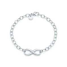 Tiffany Infinity is a powerful symbol of continuous connection, energy and vitality. Here, a classic link bracelet is given a modern twist. Sterling silver; Medium, 7.5" long | Tiffany infinity Bracelet in Sterling Silver, Medium Silver Infinity Bracelets, Tiffany Bracelets, Bracelets Design, Designer Bracelets, Tiffany Jewelry, Tiffany And Co, I Love Jewelry, My Wish List, Tiffany Blue