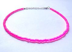 This beautiful neon pink matte beaded necklace is handmade with pink matte beads. It comes in 4 sizes (14, 16, 18, 20 inches) ranging from more of a choker fit to a longer necklace. Every necklace also comes with additional extender chain, making it easily adjustable.  The necklace makes a great gift for graduation, a birthday, or another special occasion. It is an awesome summer necklace as the color really catches the light. Summer Pink Choker As Gift, Pink Round Beads Choker For Festival, Festival Pink Round Beads Choker, Pink Choker Jewelry For Summer, Pink Choker For Summer Festival, Pink Choker For Summer, Pink Summer Choker Jewelry, Trendy Pink Festival Choker, Pink Summer Festival Choker