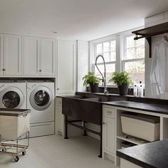 a laundry room with washers and dryers in it