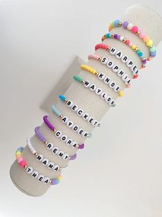 one colorful beaded name bracelet bracelets are made on a durable stretch elastic cord please refer to our sizing guide before purchasing Multicolor Name Bracelet With Letter Beads And Round Beads, Multicolor Name Bracelet With Round Letter Beads, Multicolor Name Bracelet With Letter Beads, Trendy Colorful Stretch Bracelet With Round Beads, Trendy Beaded Bracelets For Birthdays, Trendy Custom Name Jewelry With Round Beads, Trendy Beaded Bracelet For Birthday, Adjustable Name Bracelet With Colorful Beads, Colorful Adjustable Letter Beads Jewelry