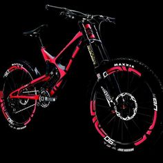 a red and black bike is shown against a black background with white writing on it