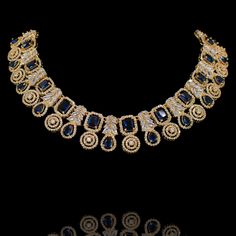 This wear-with-all piece is just perfect for those who love their statement accessories with mixed media flair! Timeless and modern, this hand crafted set dazzle with an elegant frame traced with CZ and sapphire stones. The set includes a necklace and a pair of matching earrings. Approximate earrings length is 1.5". Gold-plated on high-quality brass as base metal. Made by order. Kindly allow 5-7 weeks for the delivery of this item. For custom or urgent requests, please contact support@alacouture