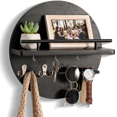 there is a wall mounted shelf with some items on it and a photo hanging from the top