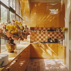 a vase filled with yellow flowers sitting on top of a counter next to a window