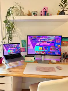 two computer monitors sitting next to each other on top of a wooden desk in front of a potted plant