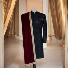 Make a statement on your big day with this ravishing black sherwani, accentuated with fine workmanship. This sherwani is aggrandized with minute handcrafted details in black and maroon, reflecting sophistication. This maroon shawl is made of velvet fabric and is accented with a golden border to give a rich, regal look. Key Features of this black designer sherwani: Premium fabric used to craft this black sherwani with intricate hand embroidery Maroon velvet shawl with golden border to add that to Luxury Black Bandhgala For Wedding, Luxury Black Bandhgala For Ceremonial Occasions, Black Traditional Wear For Groom On Eid, Traditional Black Bandhgala With Traditional Drape, Black Bandhgala For Ceremonial Festive Occasions, Ceremonial Black Bandhgala For Festive Occasions, Formal Black Traditional Wear With Dupatta, Traditional Black Ceremonial Bandhgala, Festive Black Bandhgala For Ceremonial Occasions